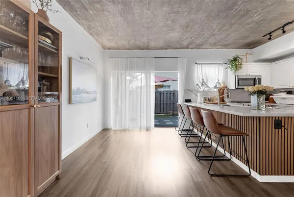 a view of a dining room with furniture window and wooden floor