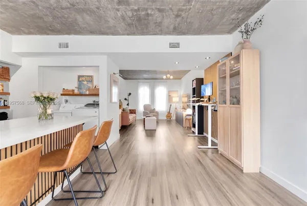 a dining room with furniture and wooden floor