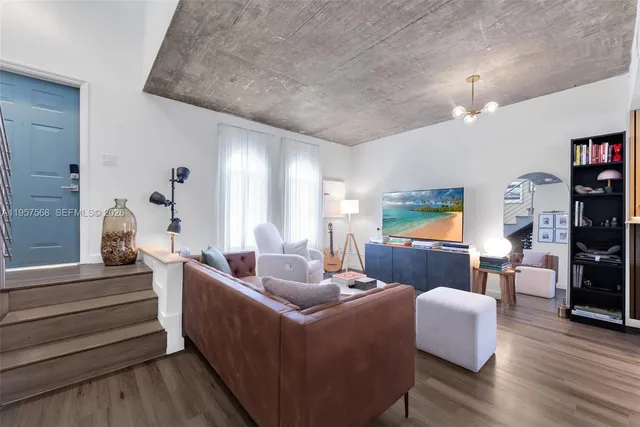 a living room with furniture and wooden floor