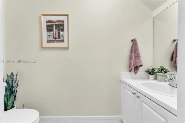 a bathroom with a sink toilet and a mirror