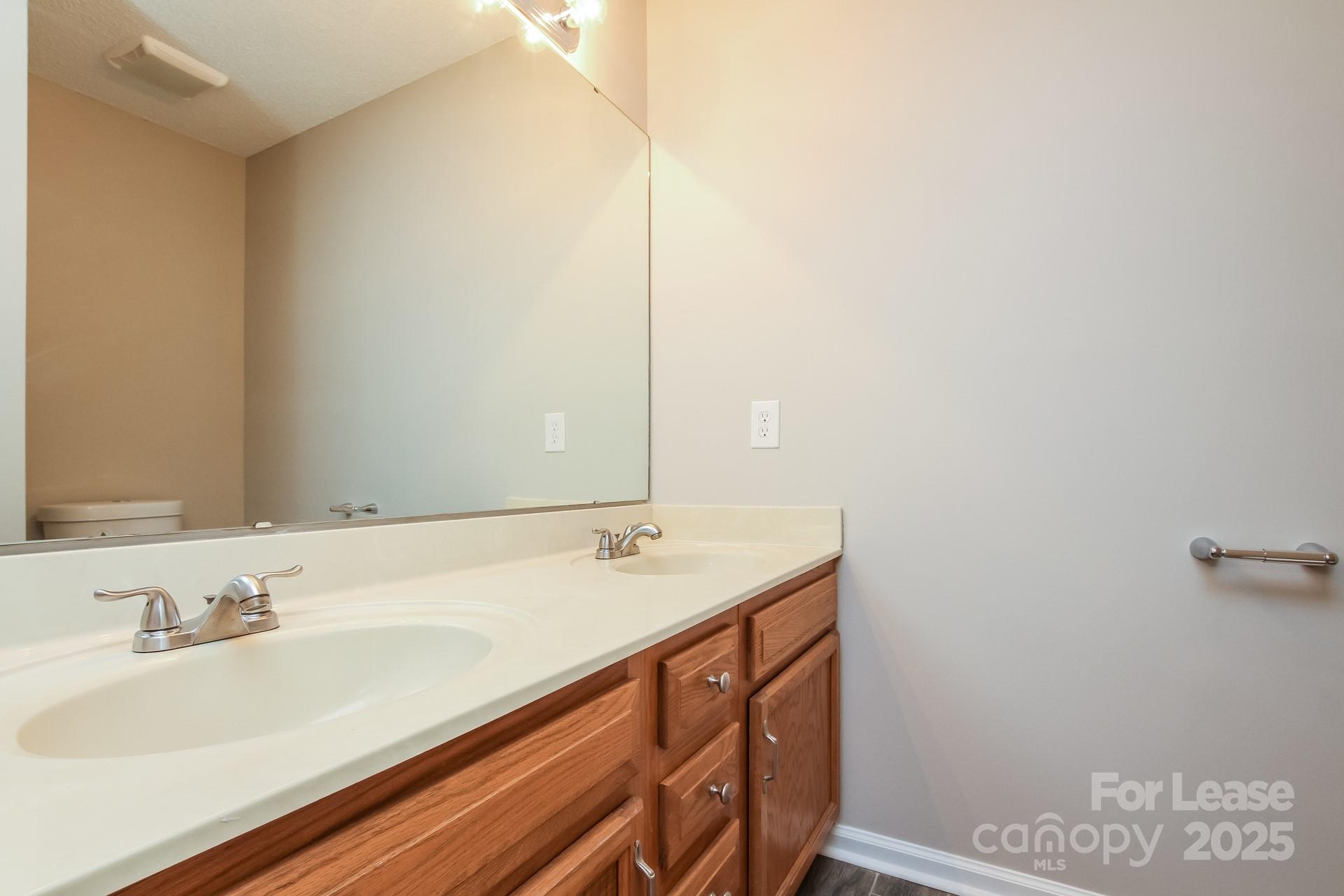 709 Firecrest Street Southeast Concord, NC 28025 - Photo 11 of 16 a bathroom with a sink and a mirror