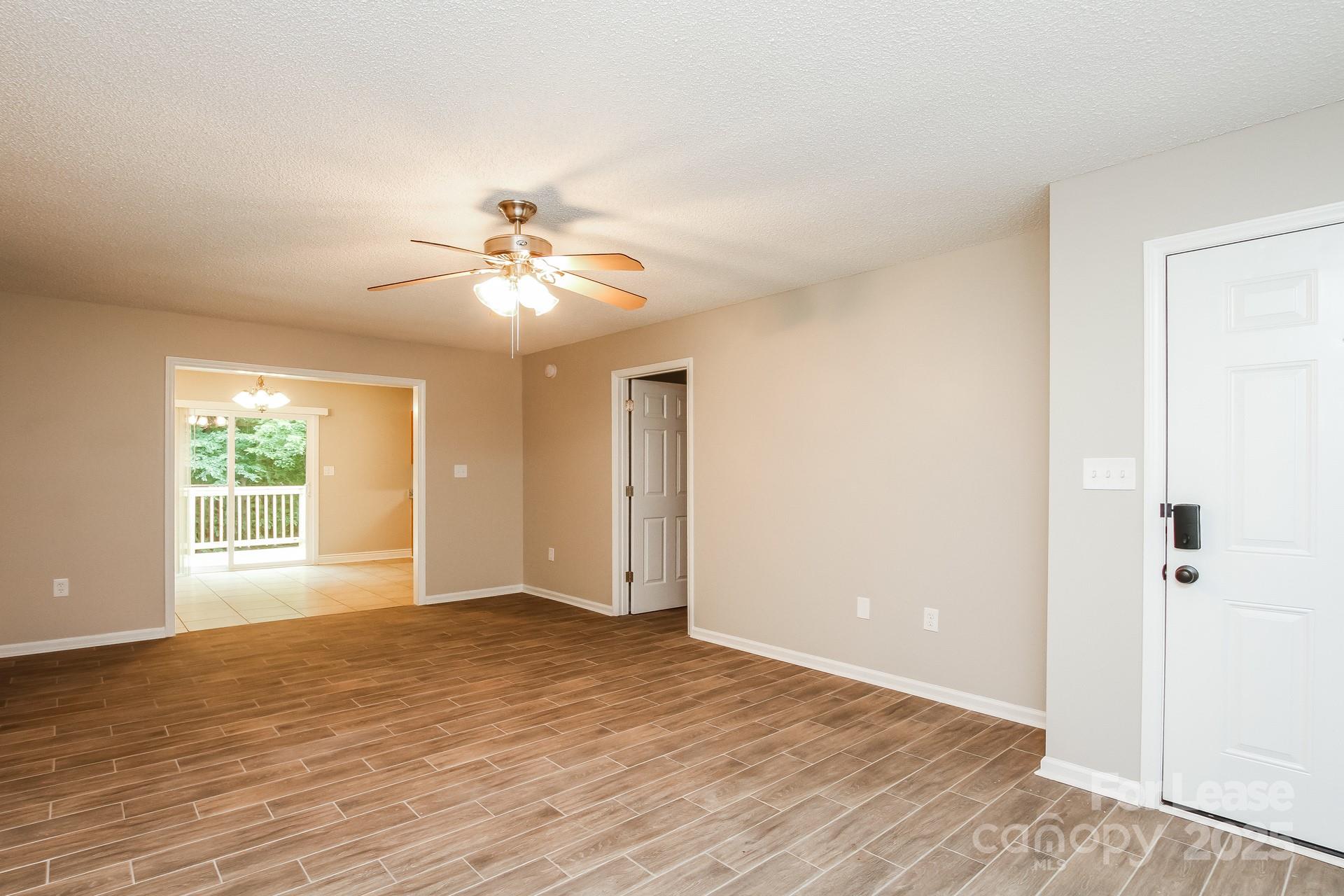709 Firecrest Street Southeast Concord, NC 28025 - Photo 2 of 16 wooden floor in an empty room with a window