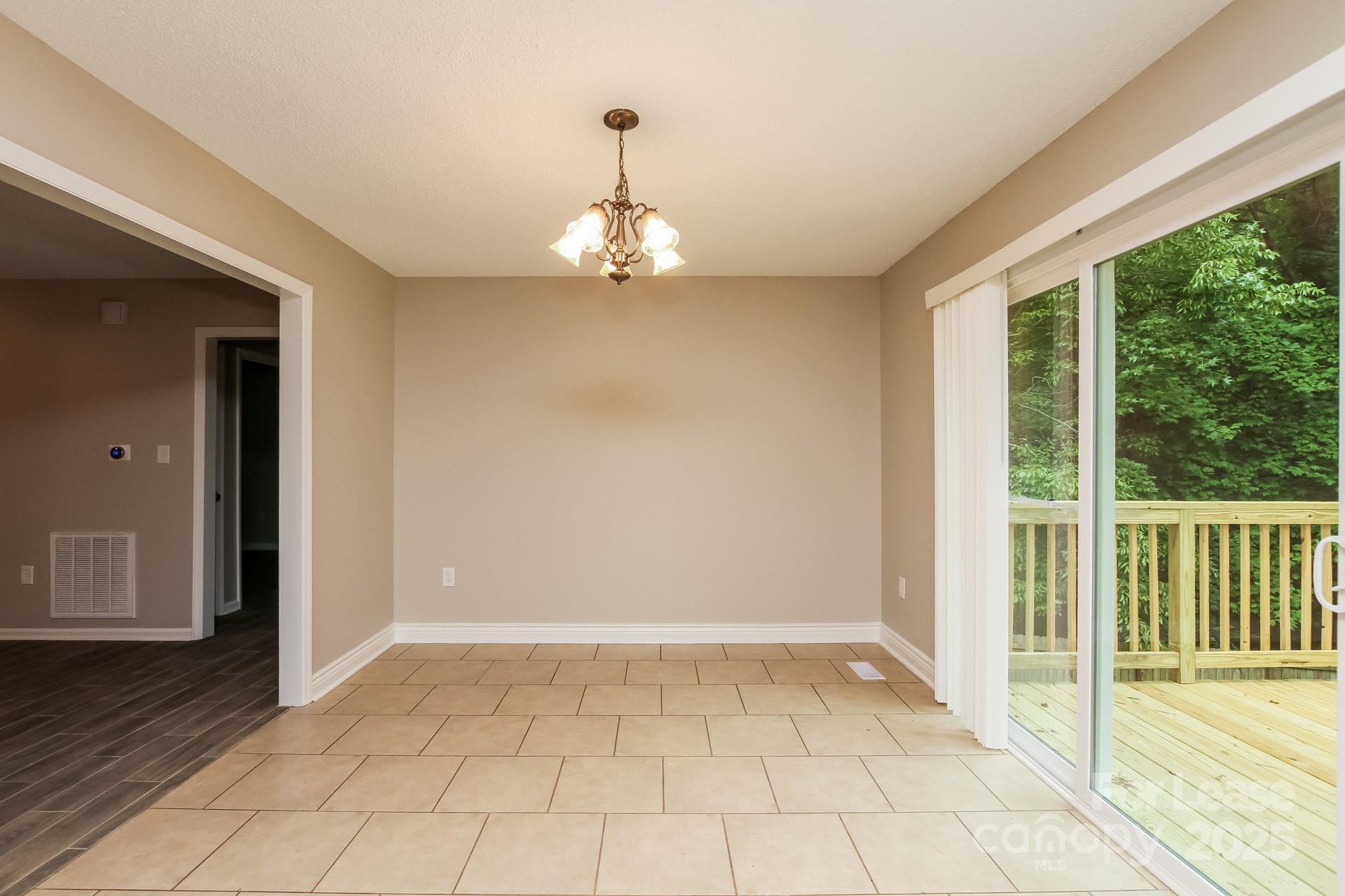 709 Firecrest Street Southeast Concord, NC 28025 - Photo 5 of 16 a view of empty room with wooden floor and fan