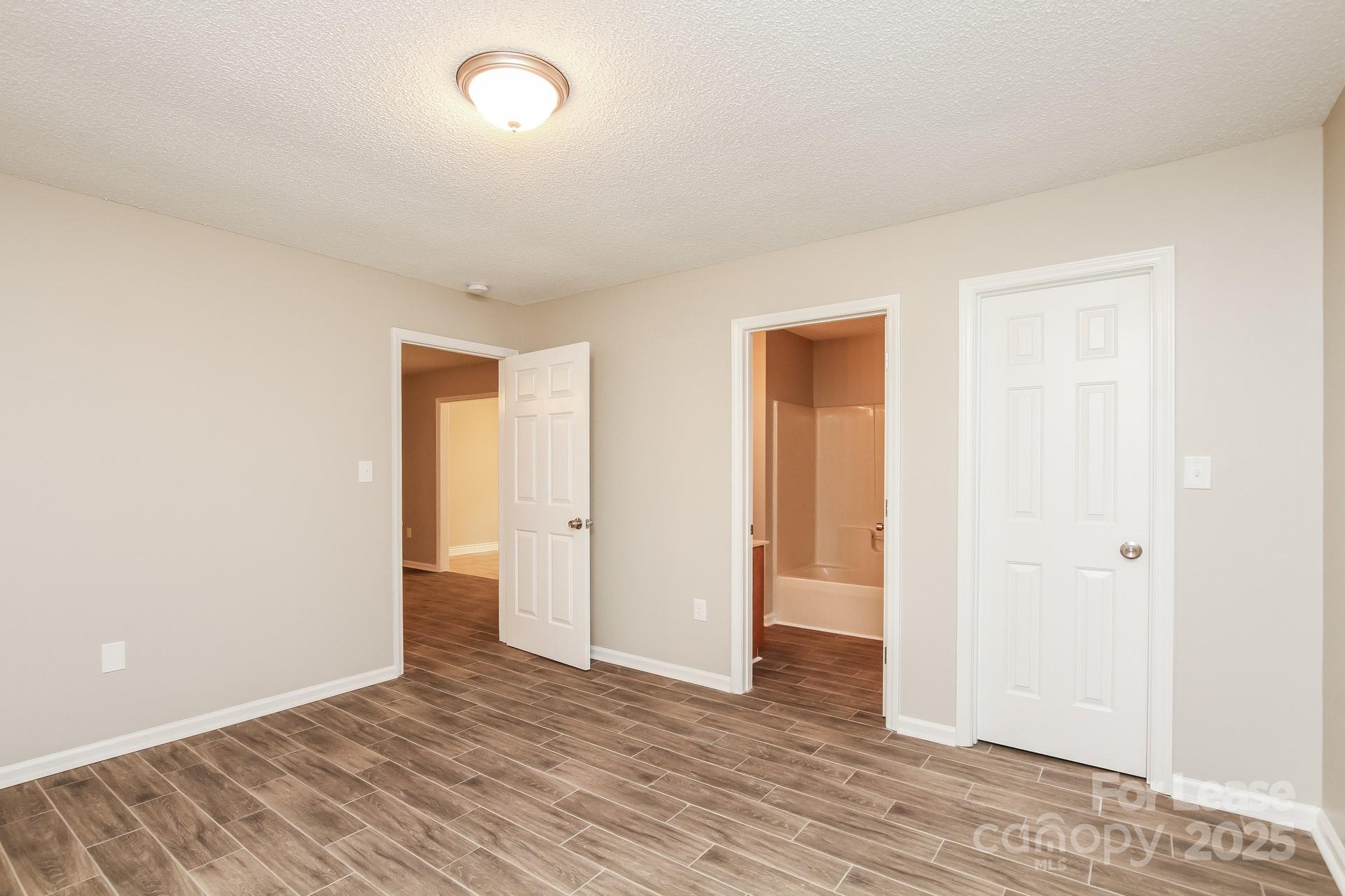 709 Firecrest Street Southeast Concord, NC 28025 - Photo 9 of 16 a view of an empty room with wooden floor and closet