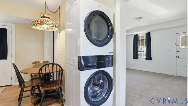 a close up of a white bed with wooden floor