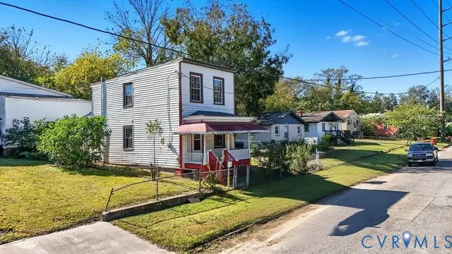 a view of a house with swimming pool and a yard