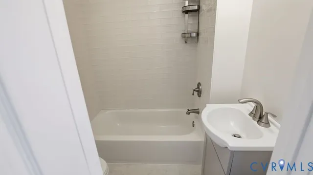 a white toilet sitting next to a bath tub