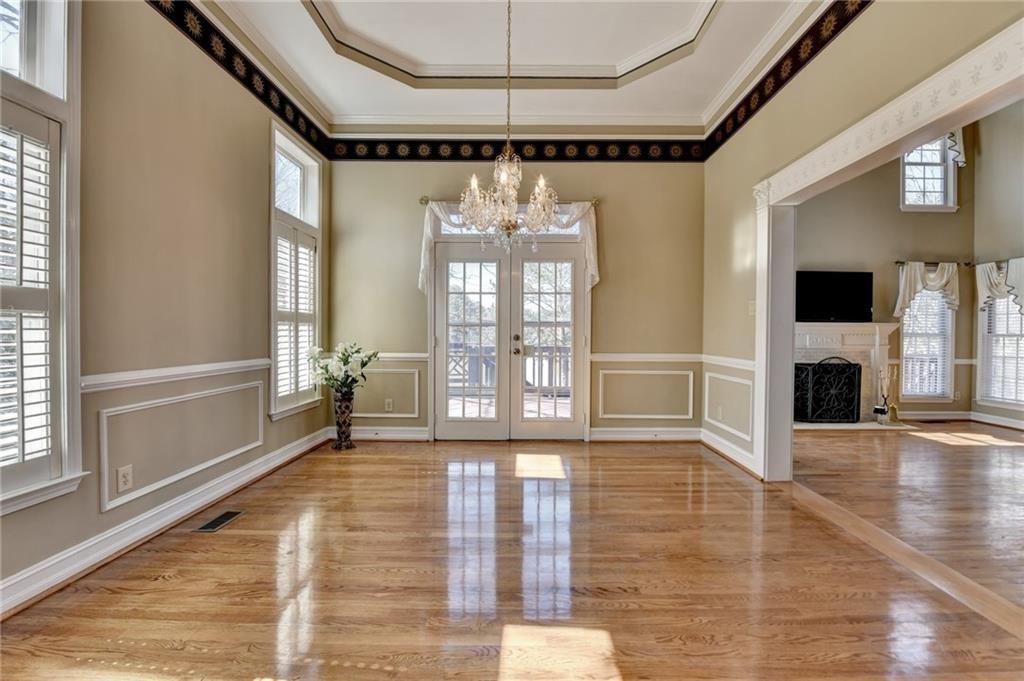 2382 Merrymount Drive Suwanee, GA 30024 - Photo 11 of 93 a view of an empty room with wooden floor and a window