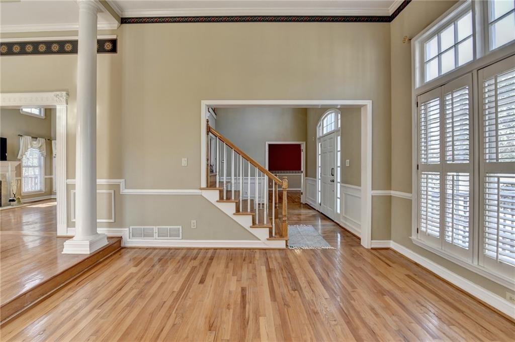 2382 Merrymount Drive Suwanee, GA 30024 - Photo 15 of 93 a view of a hallway with wooden floor and staircase