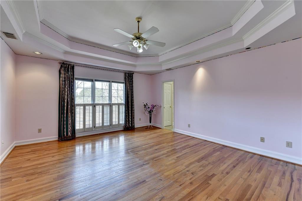 2382 Merrymount Drive Suwanee, GA 30024 - Photo 28 of 93 a view of an empty room with wooden floor and a window