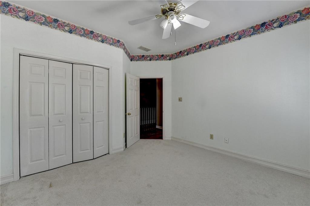 2382 Merrymount Drive Suwanee, GA 30024 - Photo 41 of 93 a view of an empty room with a chandelier fan