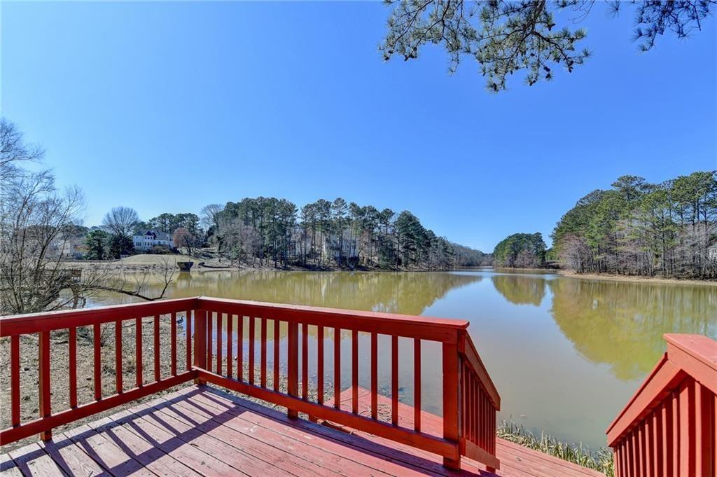 2382 Merrymount Drive Suwanee, GA 30024 - Photo 62 of 93 a balcony with wooden floor and lake view