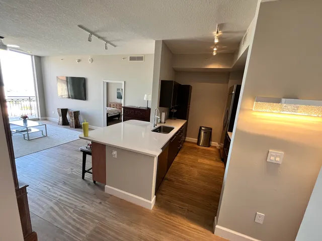 a living room with wooden floor and furniture