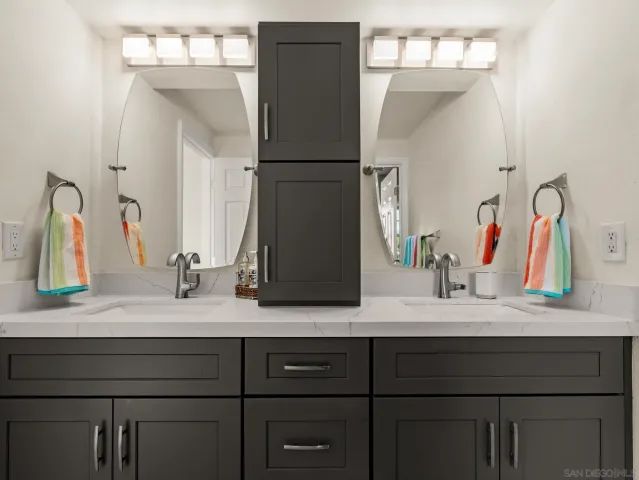 a bathroom with a double vanity sink and a mirror