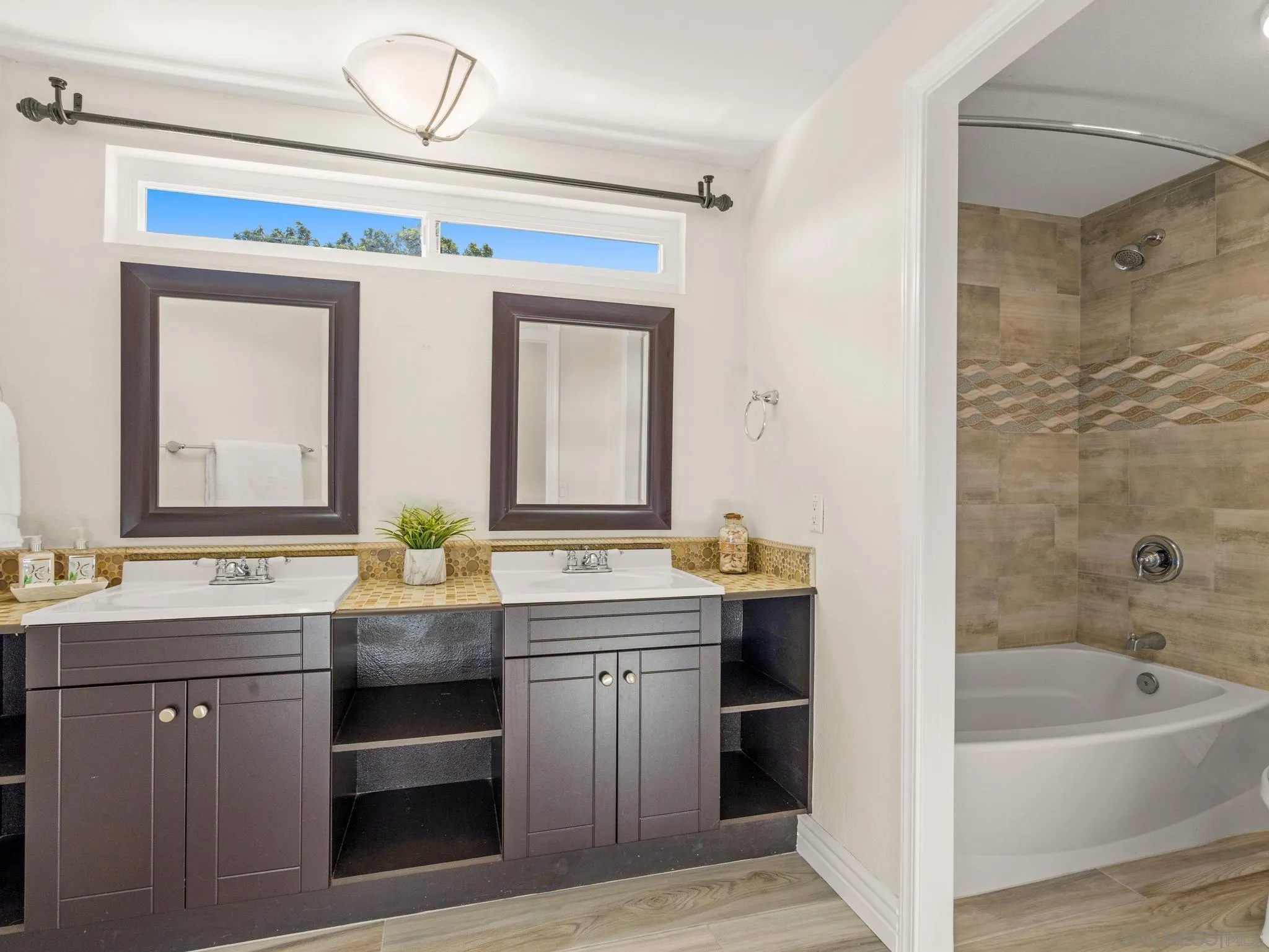 13303 Betty Lee Way Poway, CA 92064 - Photo 27 of 32 a spacious bathroom with a granite countertop sink a mirror and a bathtub