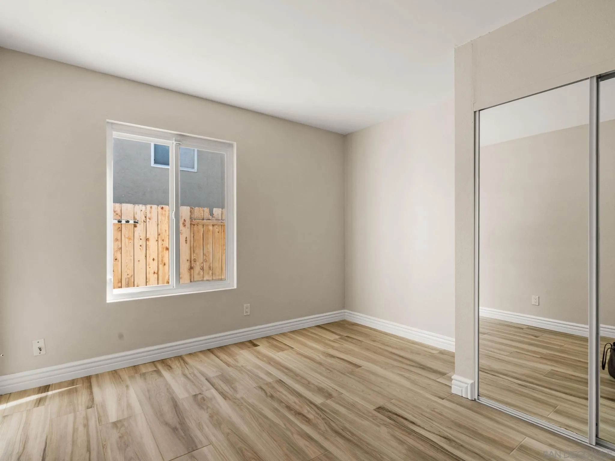 13303 Betty Lee Way Poway, CA 92064 - Photo 29 of 32 an empty room with wooden floor and windows