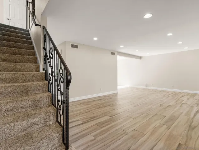 a view of entryway and hall with wooden floor