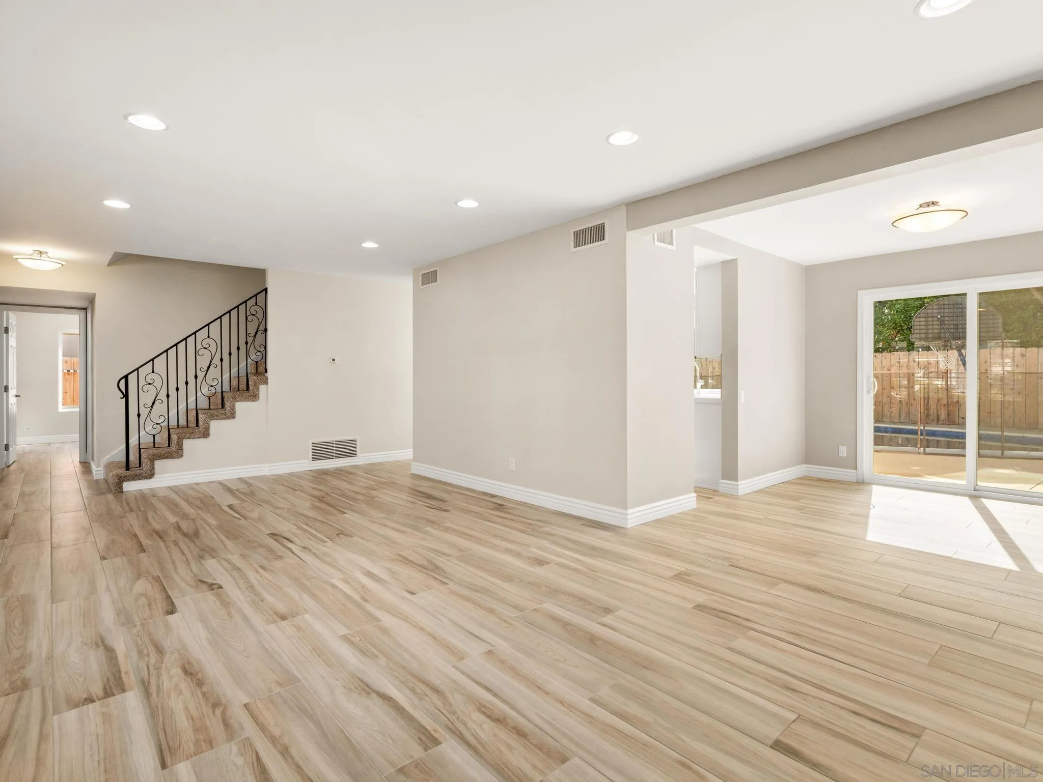 13303 Betty Lee Way Poway, CA 92064 - Photo 5 of 32 a view of an empty room with wooden floor and a window