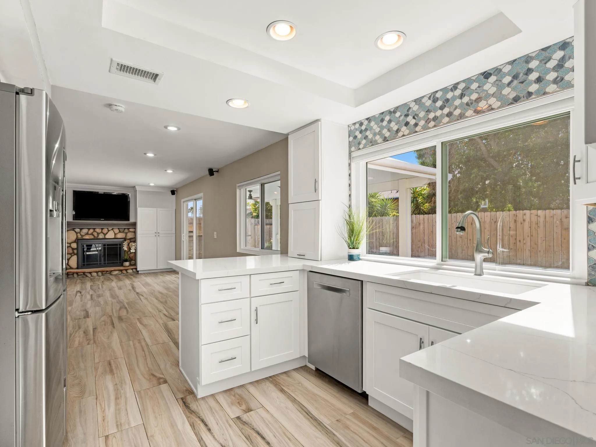 13303 Betty Lee Way Poway, CA 92064 - Photo 10 of 32 a large kitchen with stainless steel appliances granite countertop a lot of counter space and wooden floors