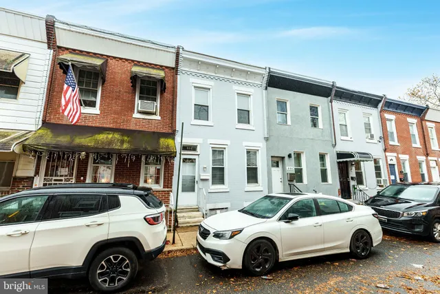 a view of a cars park in front of a building