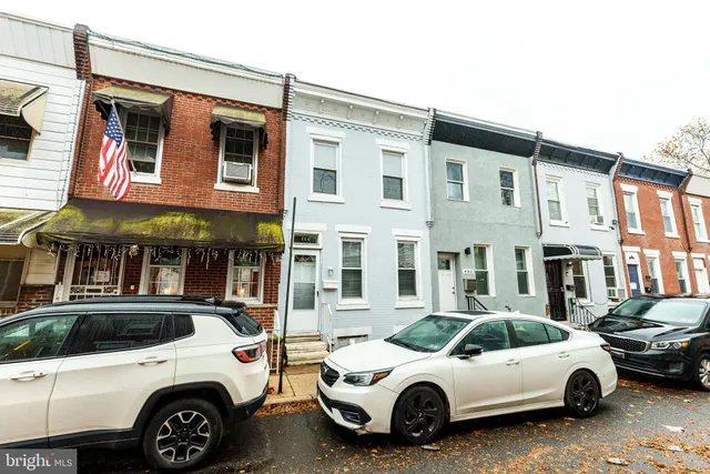 a view of a cars park in front of a building