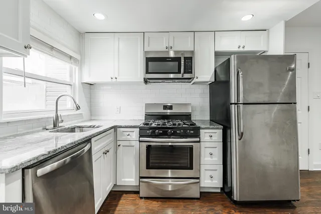 a kitchen with a stove microwave and a refrigerator