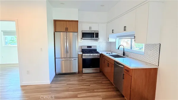 a kitchen with stainless steel appliances a refrigerator and a stove