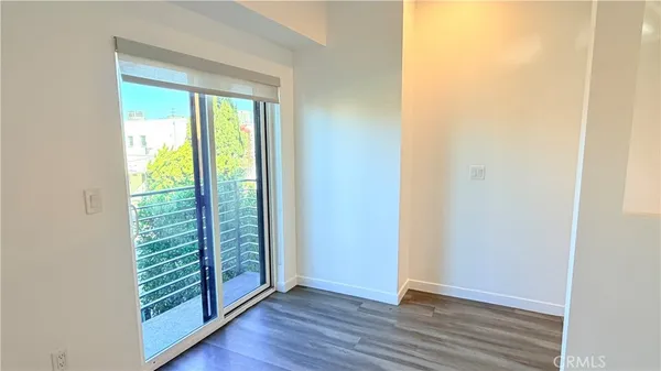 a view of an entryway with wooden floor