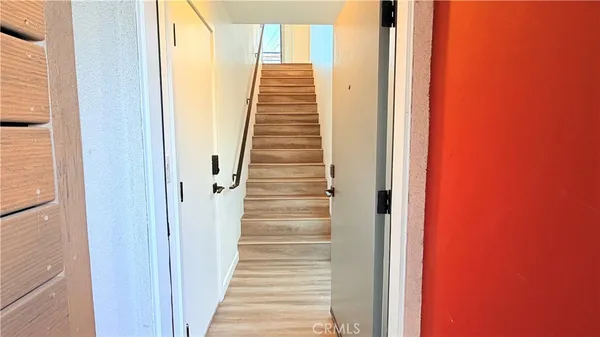 a view of a staircase with wooden floor and a window