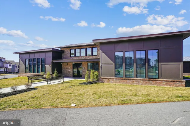 a view of a house with swimming pool and sitting area