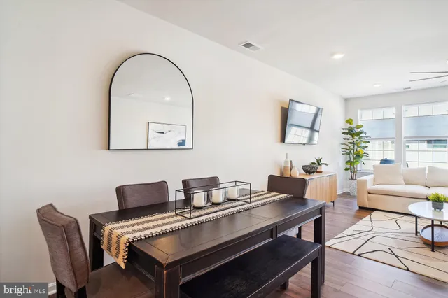 a living room with furniture a rug and a wall painting