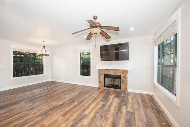 a view of an empty room with a fireplace and a window