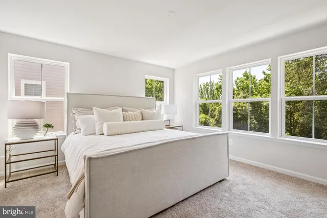 a bedroom with a bed and a large window