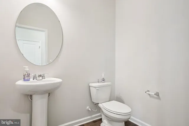 a bathroom with a sink a mirror and toilet