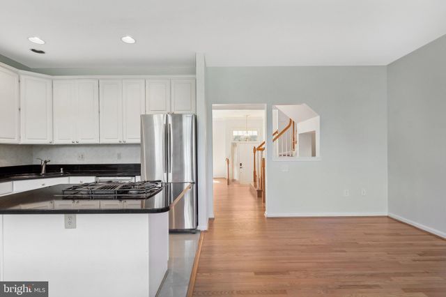 a kitchen with a refrigerator and a stove top oven