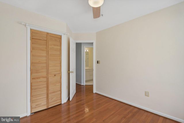 an empty room with wooden floor and closet