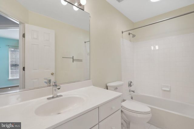 a bathroom with a sink toilet vanity and shower