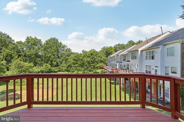 a view of balcony with wooden floor and fence