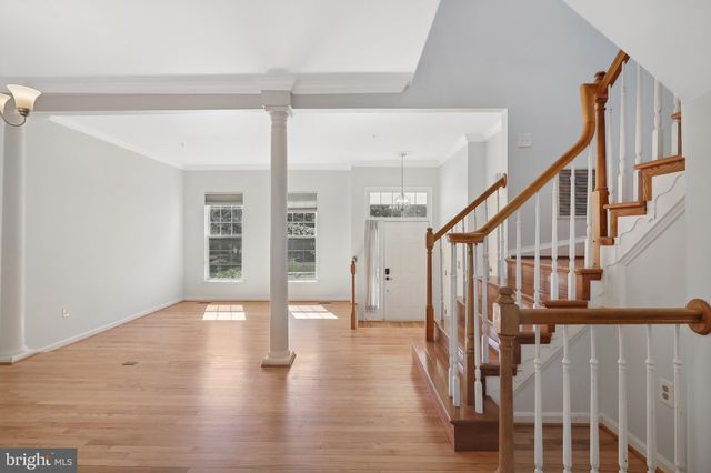 a view of an entryway with wooden floor and door