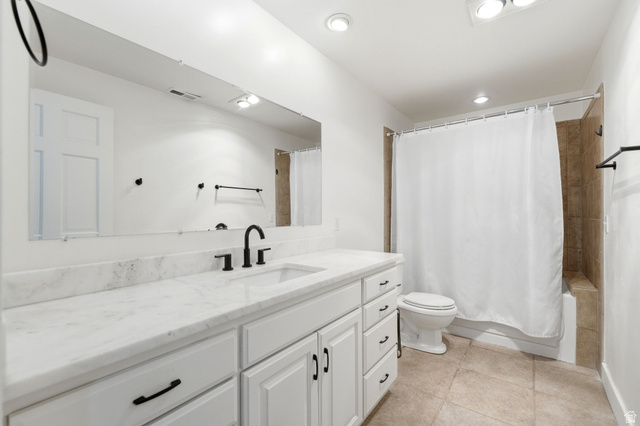 3027 Homestead Road Park City, UT 84098 - Photo 51 of 62 Contemporary bathroom featuring a white vanity with integrated sink, black fixtures, and a large mirror