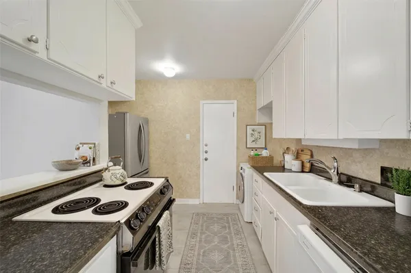 a kitchen that has a sink and a stove in it