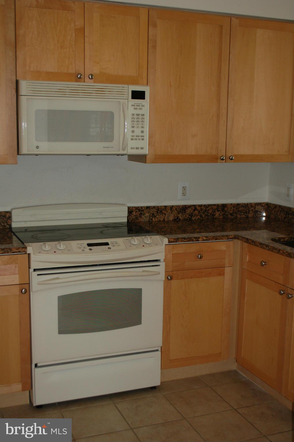 3101 North Hampton Drive, Unit 109 Alexandria, VA 22302 - Photo 2 of 10 a stove top oven sitting inside of a kitchen