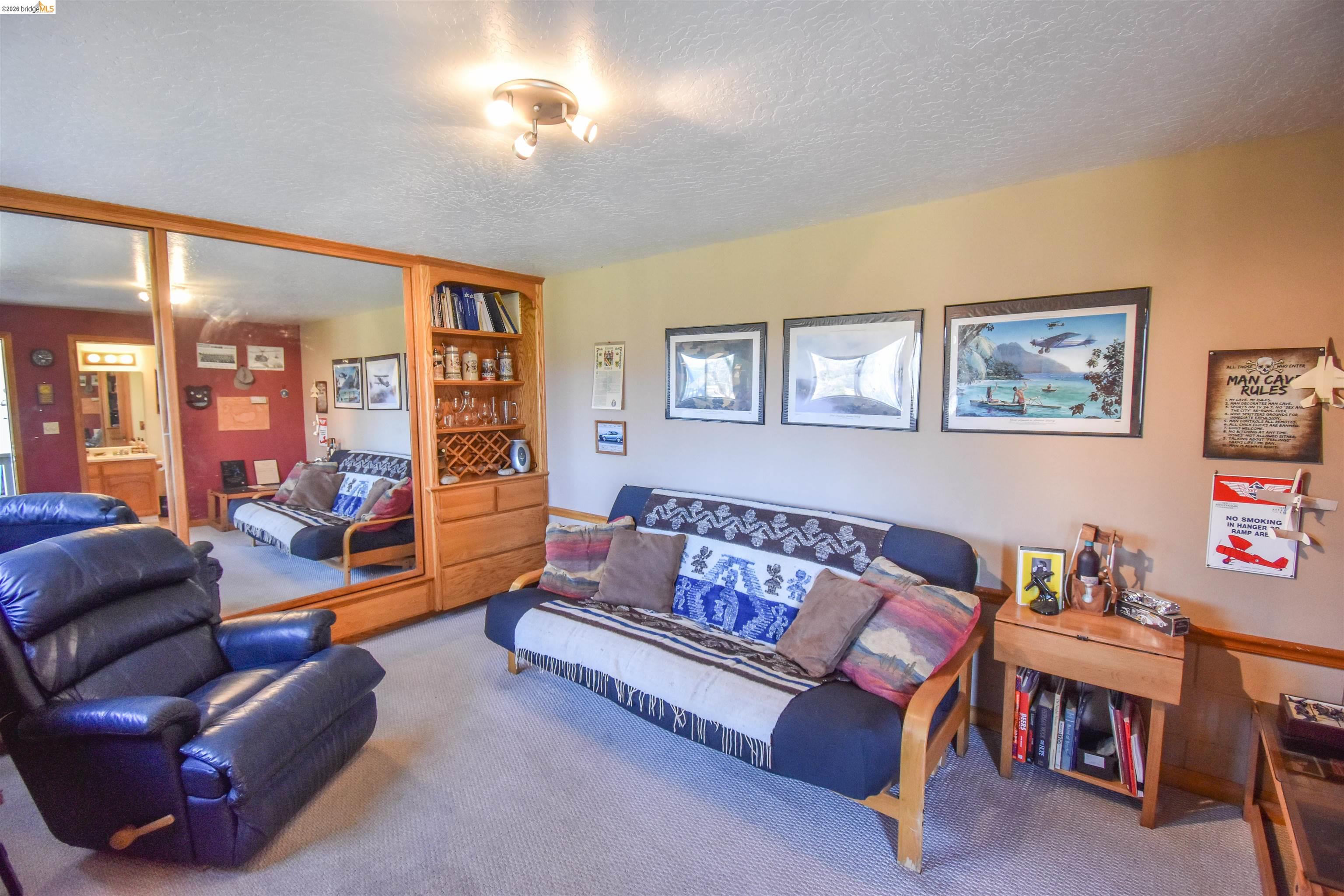 15170 Potato Ranch Road Sonora, CA 95370 - Photo 34 of 49 Carpeted living room featuring a textured ceiling