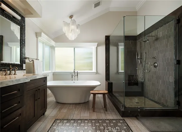 a spacious bathroom with a double vanity sink mirror and shower