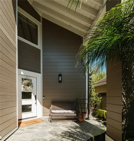 a view of house with backyard space and potted plants