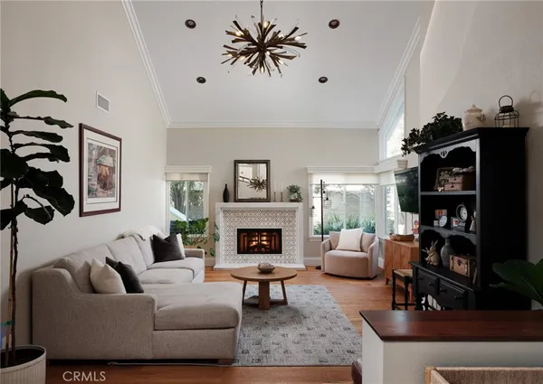 a living room with furniture a fireplace and a flat screen tv