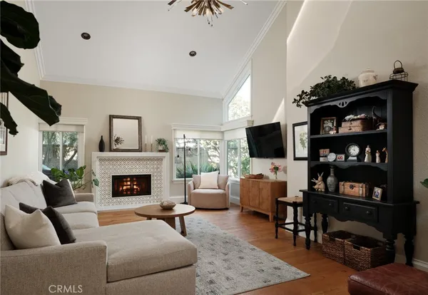 a living room with furniture a flat screen tv and a fireplace