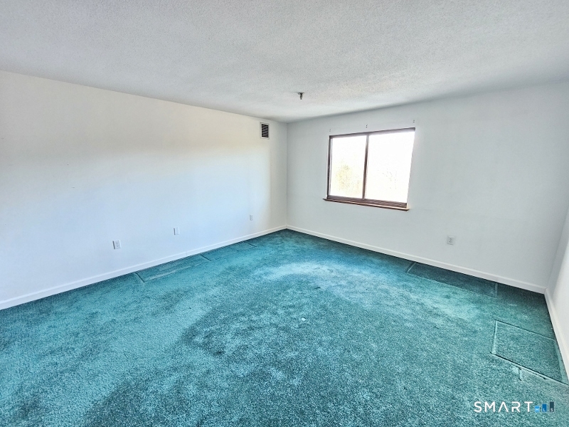 45 Putter Drive, Unit 509 Wallingford, CT 06492 - Photo 11 of 13 an empty room with a window