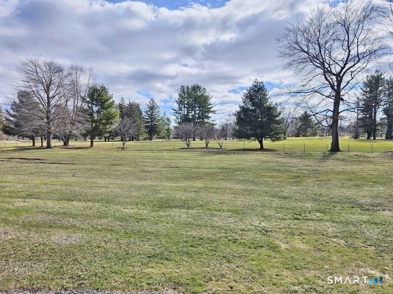 45 Putter Drive, Unit 509 Wallingford, CT 06492 - Photo 13 of 13 a view of a green field with trees in the background