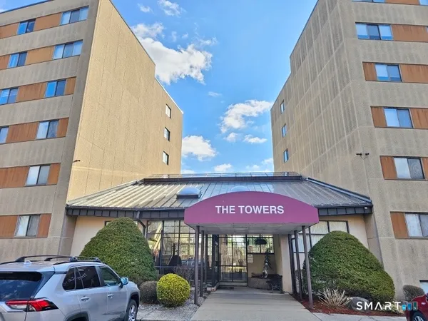 a view of a cafe with a table and chairs under an umbrella